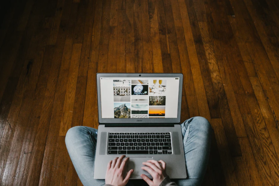 person using laptop on lap photo